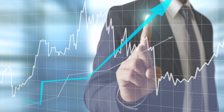 46795866 - businessman with financial symbols coming from han The Right Trading Strategies Can Lead to Financial Freedom