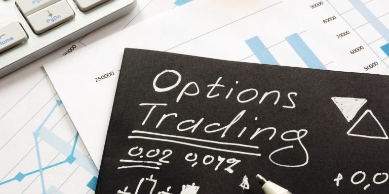 Options trading written on black piece of paper.