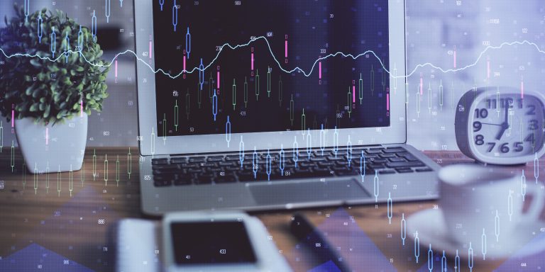 Financial graph colorful drawing and table with computer on background. Multi exposure. Concept of international markets.